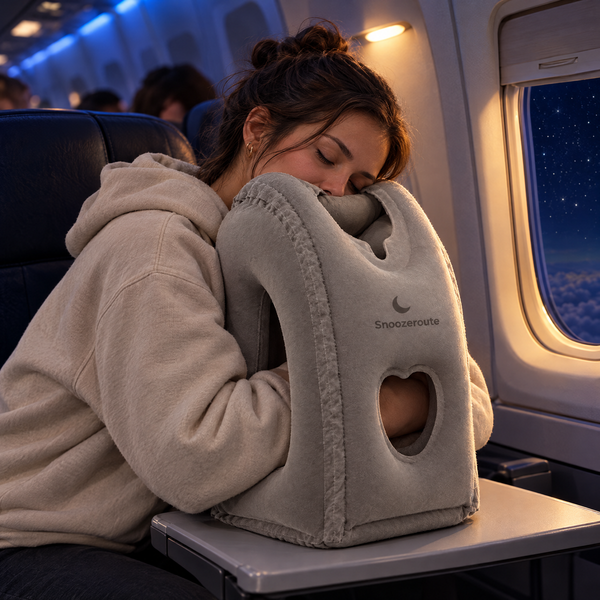 Traveler sleeping forward on The Snooze Pillow on a night flight