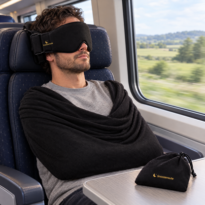 Traveler resting with The Snooze Set on a train